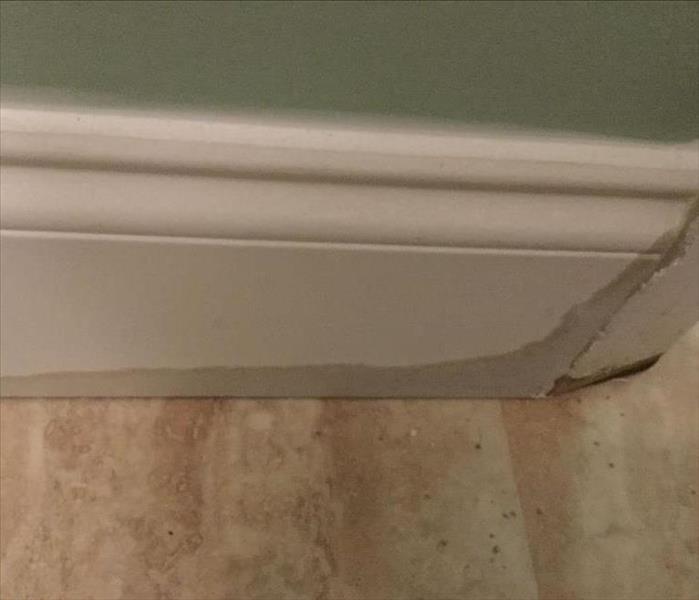 Wet baseboards after a water loss.