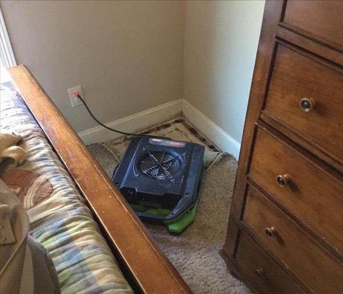 Air mover in corner of a bed room.
