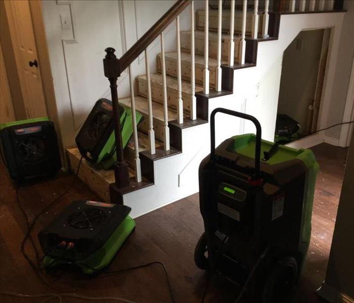 Home with air movers around the stairs